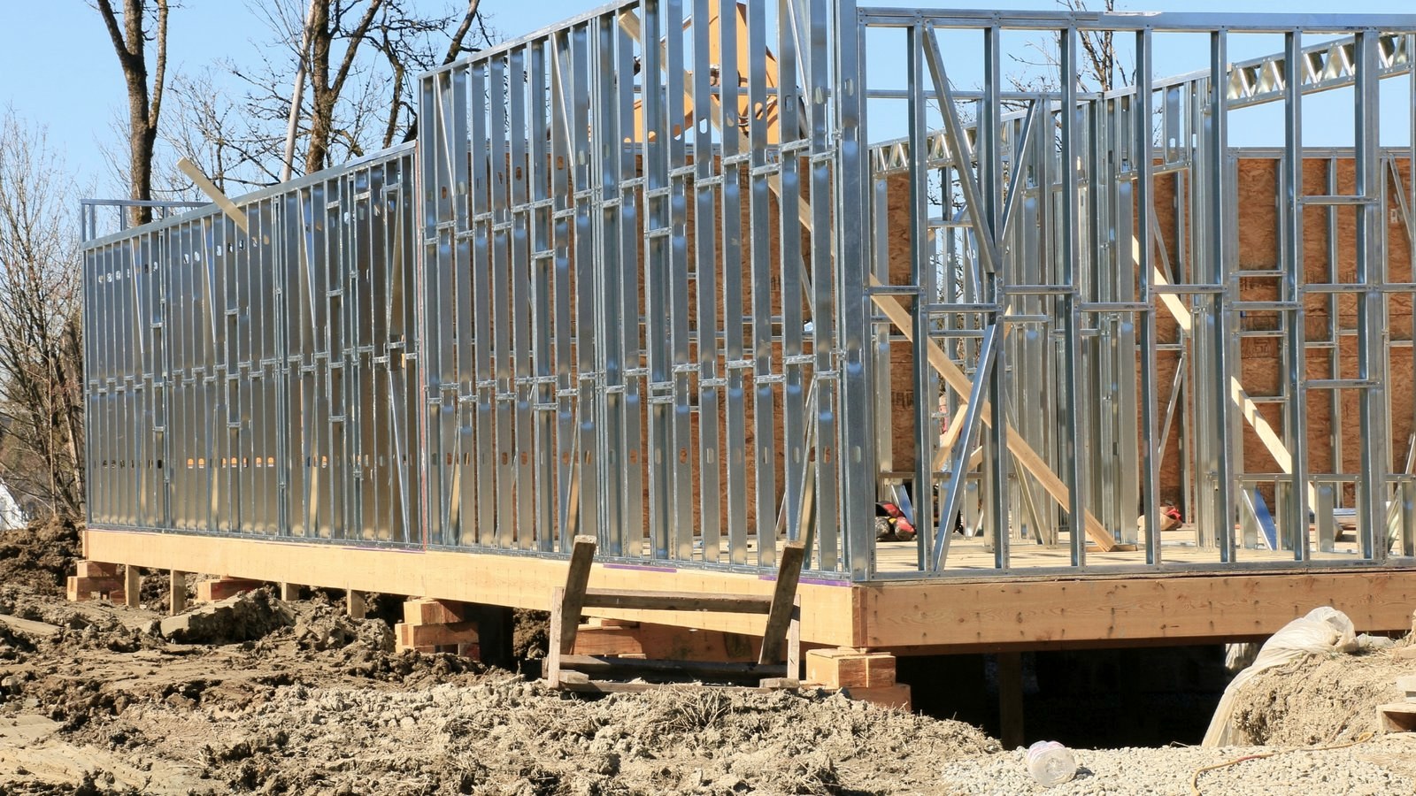 Painéis de steel frame montados sobre a fundação, com terreno em obra
